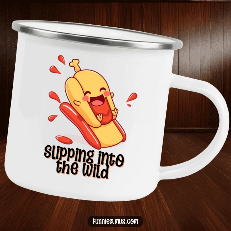 Funny hot dog camping mug depicting a hot dog in a bun sliding down a ketchup slide, a humorous and durable mug for outdoor enthusiasts.