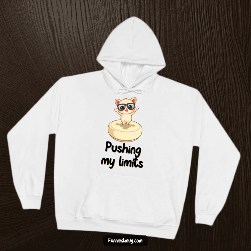 Funny Little Creature Hoodie showing the character with oversized glasses joyfully dancing on a button, offering comfort and funny vibes.