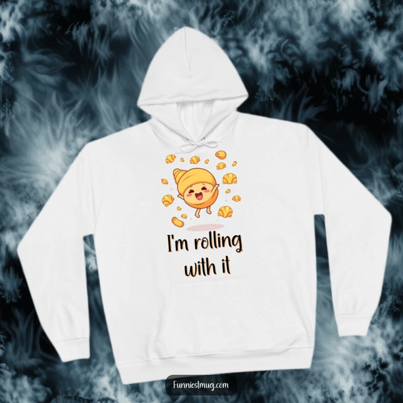 Funny hoodie depicting a joyful croissant character executing a cartwheel, with buttery croissants flying playfully, creating a hilarious and cozy baking-themed design.